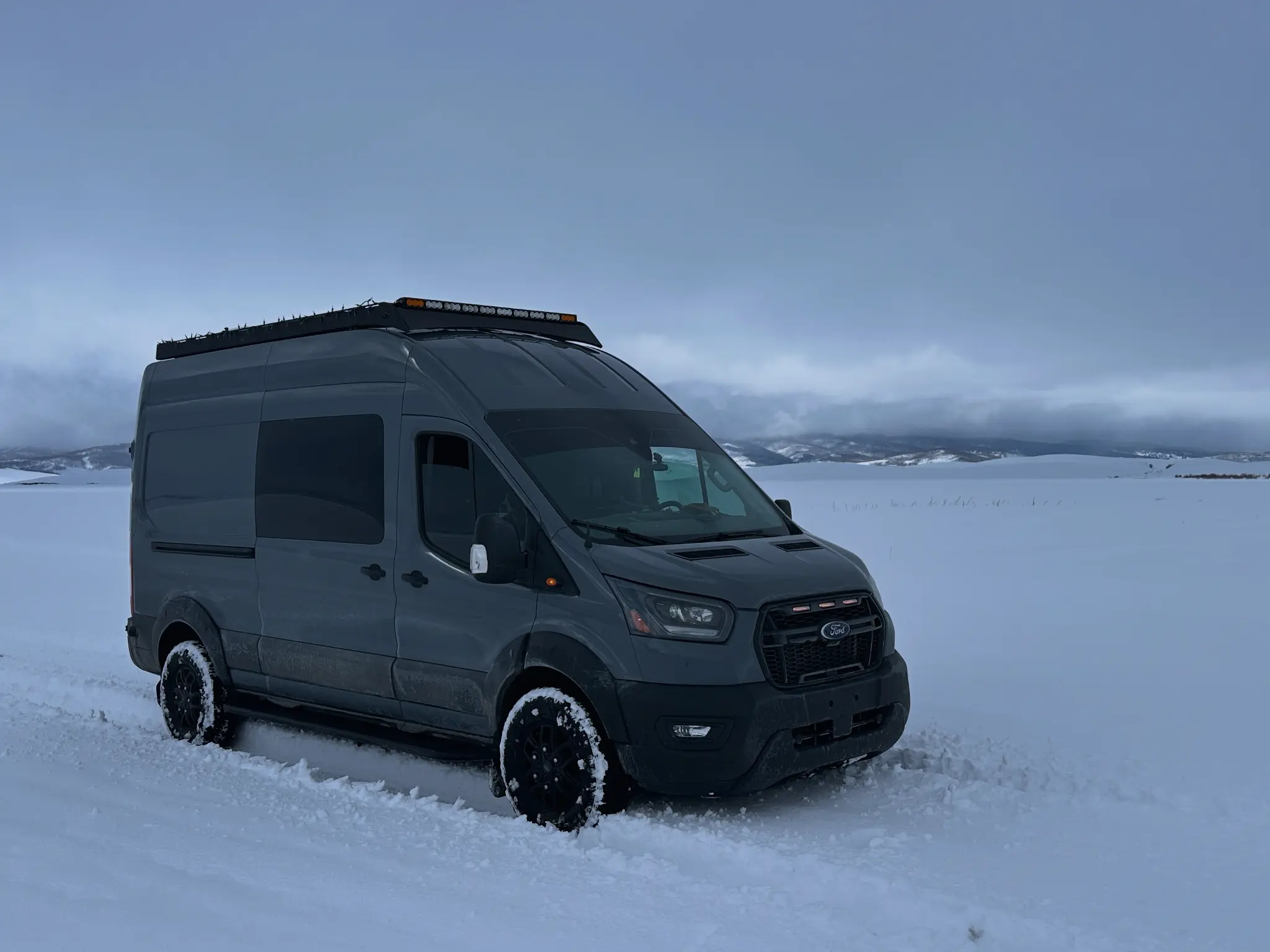 Ford Transit Trail van in the snow after a dashcam and LED light bar install