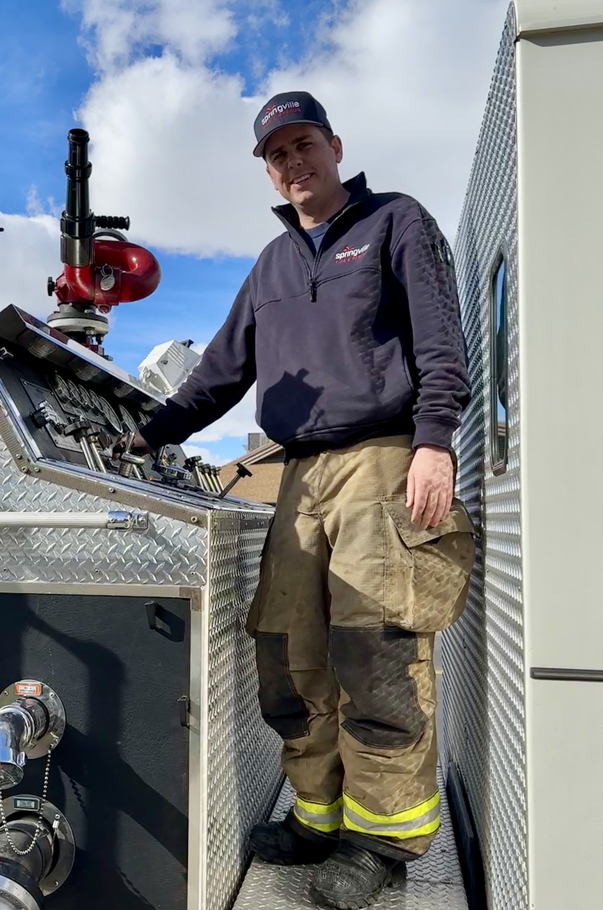 Parker Boyack standing on emergency apparatus in Utah